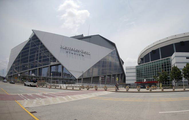 Mercedes-Benz Stadium, left, the new home of the Atlanta Falcons football team and the Atlanta United soccer team, is shown next to the Georgia Dome in Atlanta on Tuesday. [AP Photo/John Bazemore/File]