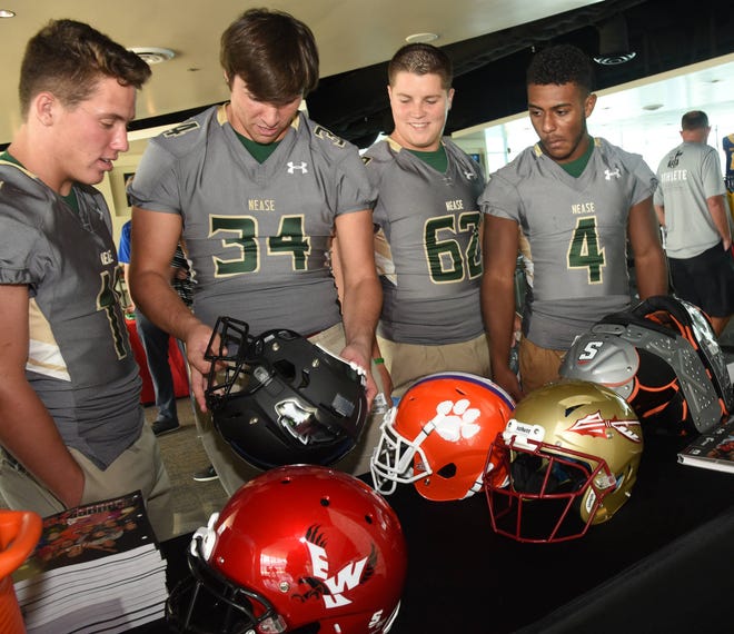 Nease High School Panthers (from left) Ashton Wood, Zach Sheffer, Elijah Von Almen and Jareem Westcott, check out the new Schutt helmets on display at the Baker Sporting Goods high school football media day EverBank Field on Tuesday August 1, 2017. Over 50 local teams brought their top players and coaches for the 2017 season. (Bob Mack/Florida Times-Union)