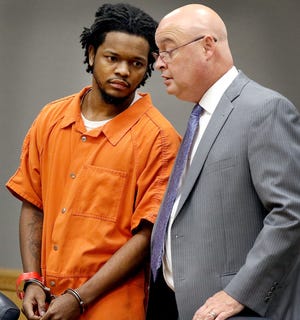 Naijii Salik Boyd talks with his attorney Rick Beam during his hearing at the Gaston County Courthouse Monday. Boyd, who is charged with first-degree murder in the 2016 shooting death of David Clint Watson near Bessemer City. Boyd turned down a plea offer of 34-years in prison and pleaded not guilty. [JOHN CLARK/THE GASTON GAZETTE]