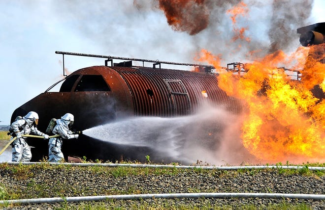 (File photo) Airmen and Marines battle a fire surrounding a mock aircraft frame June 10, 2011, during a joint firefighting course at Joint Base McGuire-Dix-Lakehurst. Although water was used in this drill, historically firefighting foam containing PFOS was used instead. Although PFOS and PFOA have not been detected in any Burlington County water supplies, sampling has found the chemicals are widespread in other water systems throughout the state.