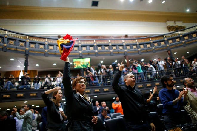 Anti-government lawmakers shout "Fraud," during a session of Venezuela's National Assembly, in Caracas, Venezuela, Wednesday. The National assembly's claim of a fraudulent election was bolstered when the CEO of the voting technology company Smartmatic said Wednesday that results of Venezuela's election for the all-powerful constituent assembly were off by at least 1 million votes.
