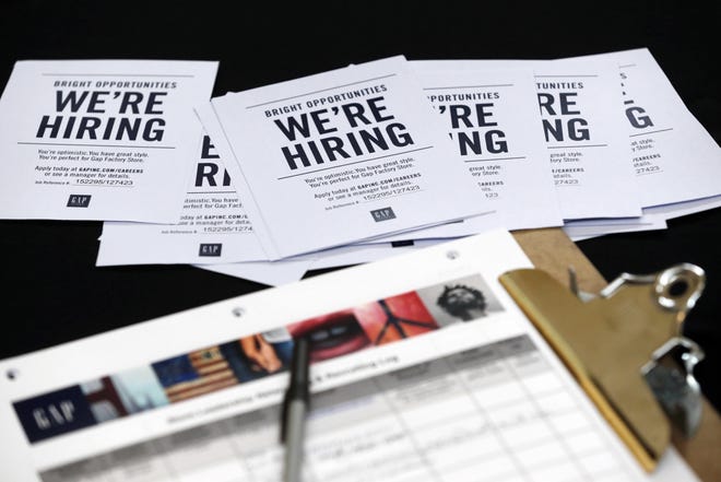 Job applications and information for the Gap Factory Store rest on a table during a job fair at Dolphin Mall in Miami. The US economy has acquired an exclusive label: Recession-free for eight full years. [AP Photo/Wilfredo Lee, File]
