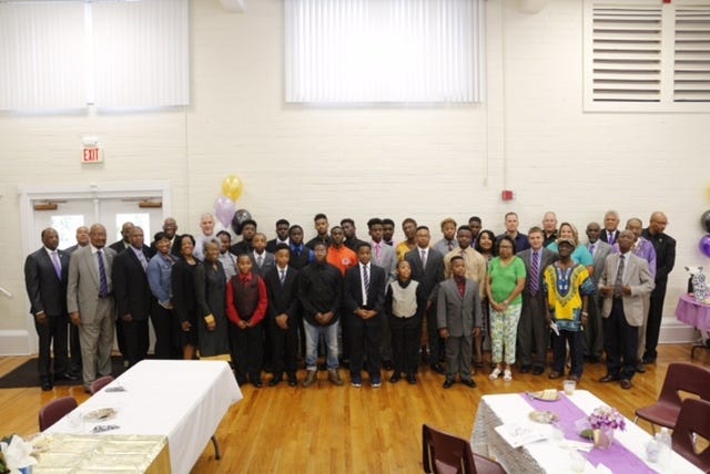 The young men of the Manhood Youth Foundation Inc., along with mentors, parents and supporters attending the annual graduation ceremony. [Photos Special to the Guardian]