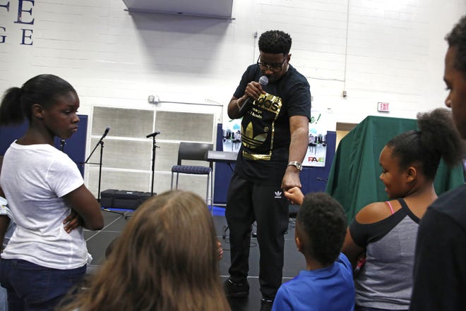 Christopher "Play" Martin talks to the crowd during the annual Stop the Violence/Back to School Rally held Saturday at Santa Fe College. [Andrea Cornejo/Special to the Guardian]