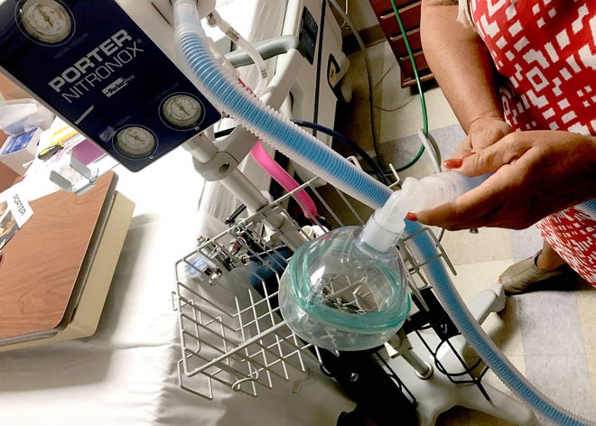 A representative from Praxair Healthcare Services demonstrates how to hook up the nitrous oxide equipment from Hatfield-based Porter Instrument, during a training with staff at Holy Redeemer Hospital in Abington on Tuesday, Aug. 2, 2017. The hospital will begin offering nitrous oxide to mothers during delivery as an alternative to other pain management options like epidurals.