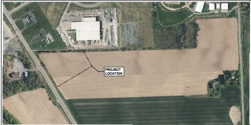 This aerial photo shows the site for the Tractor Supply Store. The white building at top center is Coach & Equipment in Horizon Business Park.