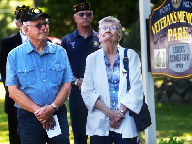 Emily Repp looks upward as Charles S. Hatch Post #79 Commander, Jeff Chase, reads about her husband, Dick Repp's accomplishments in the service. Emily was awarded a Certificate of Initiation into the American Legion Auxiliary at Veteran's Memorial Park on Thursday morning. Standing next to Mrs. Repp is past commander, Ron Vigue.
[Deb Cram/Fosters.com]