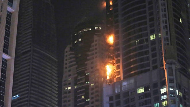 Smoke and fire rise from a high rise building at Marina district in Dubai, United Arab Emirates, Friday, Aug. 4, 2017. (Associated Press)