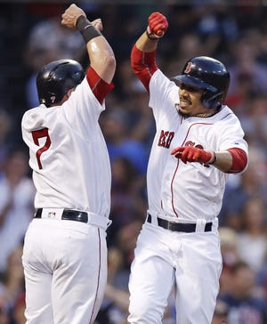 Red Sox outfielder Mookie Betts (right) celebrates with Xander Bogaerts after hitting a two-run home run off Chicago White Sox starting pitcher Miguel Gonzalez during the second inning of Boston's 9-5 win on Thursday night at Fenway Park.