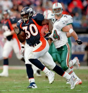 Denver Broncos running back Terrell Davis breaks away for a long run against the Miami Dolphins during the third quarter of action at Mile High Stadium on Saturday, Jan 9, 1999. (AP Photo/David Zalubowski)