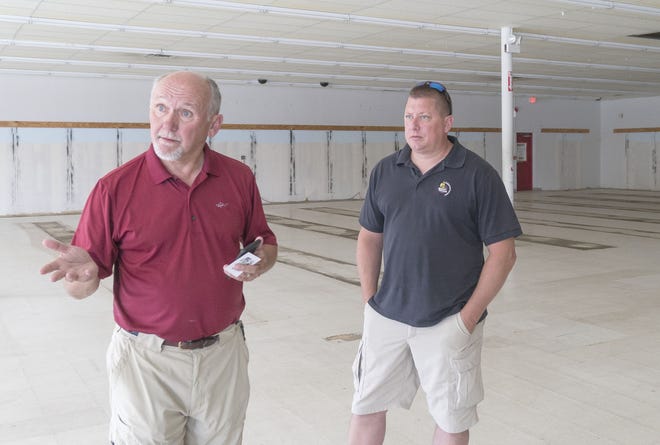 Steve Eddleston, left, of Bristol is opening a Planet Fitness gym in the former Rocky’s Ace Hardware space on West Main Road in Middletown. It will be his 14th Planet Fitness gym. At right is Rich O’Neil, a contractor from New Jersey who will manage the renovation of the space.