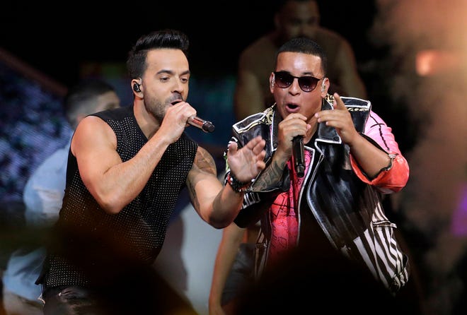 FILE - In this April 27, 2017 file photo, singers Luis Fonsi, left and Daddy Yankee perform during the Latin Billboard Awards in Coral Gables, Fla. On Friday, Aug. 4, 2017, YouTube announced that the music video for the No. 1 hit song “Despacito” has become the most viewed clip on YouTube of all-time. (AP Photo/Lynne Sladky, File)