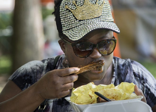 Cynthia Hill of Stockton digs in to barbecued ribs at Saturday's Soul Food Festival at Weber Point Event Center. The annual event is sponsored by the African American Arts & Culture Community Center. [CLIFFORD OTO/THE RECORD]