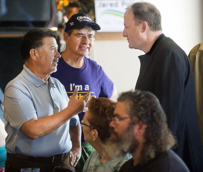 CHIEFTAIN PHOTO/BRYAN KELSEN Democratic candidate for governor Jared Polis (right) talks with Abel Tapia (left) as Alvin Rivera looks on during a meet and greet with the candidate Saturday in Pueblo.
