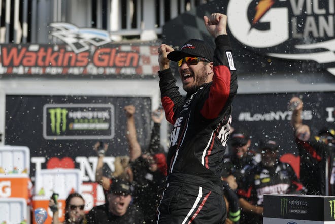 Martin Truex Jr. celebrates after winning the NASCAR Cup Series auto race, Sunday, Aug. 6, 2017, in Watkins Glen, N.Y. (AP Photo/Matt Slocum)