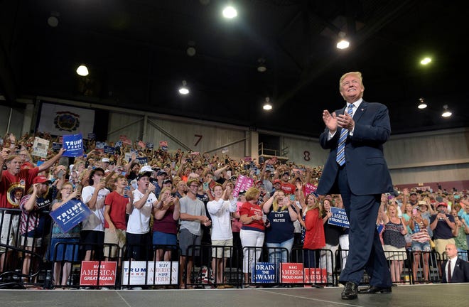 In this Aug. 3, 2017, photo, President Donald Trump arrives to speak at a campaign-style rally at Big Sandy Superstore Arena in Huntington, W.Va. (AP Photo/Susan Walsh)