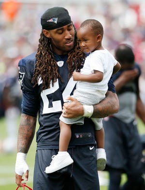 New England Patriots cornerback Stephon Gilmore and his son Sebastian during NFL football training camp, Friday, July 28, 2017, in Foxboro.
