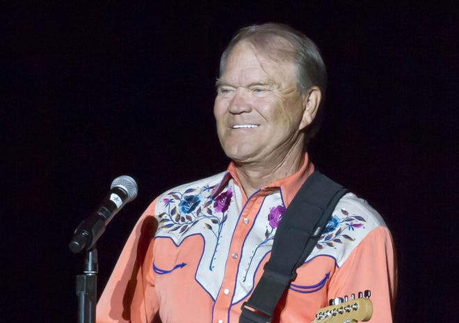 This Sept. 6, 2012 file photo shows singer Glen Campbell performing during his Goodbye Tour in Little Rock, Ark. Campbell, the grinning, high-pitched entertainer who had such hits as "Rhinestone Cowboy" and spanned country, pop, television and movies, died Tuesday. He was 81. [AP Photo/Danny Johnston, File]