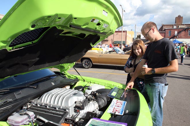Andrew Kloften of Janesville, Wis., and Amanda Erbsen of Pearl City look at one of the classic cars on display at Cruise Night on Aug. 13, 2016, in downtown Freeport. [THE JOURNAL-STANDARD FILE PHOTO]