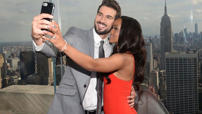 Bachelorette Rachel Lindsay and fiancé Bryan Abasolo make their love Instagram official while celebrating at Bar SixtyFive at the Rainbow Room in N.Y.C. on Tuesday.