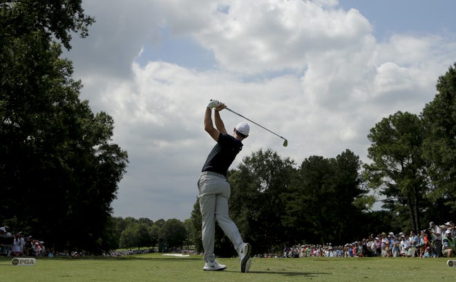 Rory McIlroy watches his tee shot on the sixth hole during the first round of the PGA Championship at the Quail Hollow Club on Thursday in Charlotte, N.C. [THE ASSOCIATED PRESS / CHUCK BURTON]