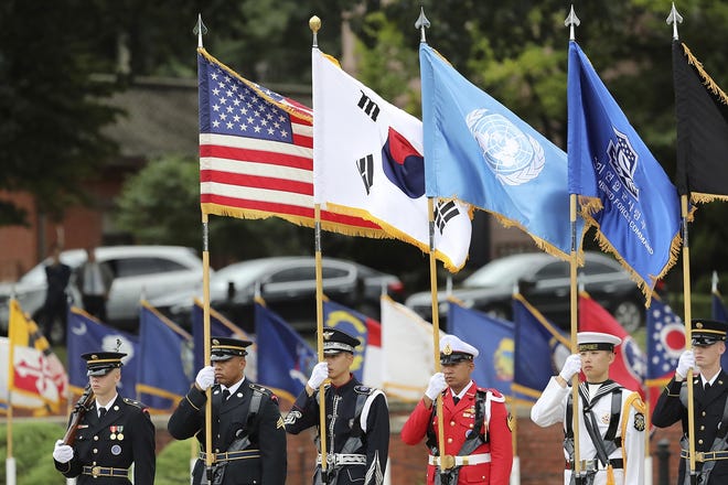 U.N. Command honor guards carry flags of the United States, the United Nations and South Korea during a change of command and change of responsibility ceremony for Deputy Commander of the South Korea-U.S. Combined Force Command at Yongsan Garrison, a U.S. military base, in Seoul, South Korea, Friday, Aug. 11, 2017. (AP Photo/Lee Jin-man)