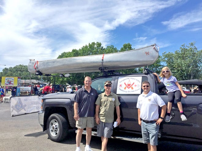 Dan Riggle, Bryan Bigley, Ben Kois and Bigley's daughter Raegan rode in the Johnny Appleseed Festival on July 29 to raise awareness for their upcoming Paddling for the Cure canoe trip. Kois and Bigley will depart from New Philadelphia on Saturday and reach the Ohio River in Marietta on Aug. 18.