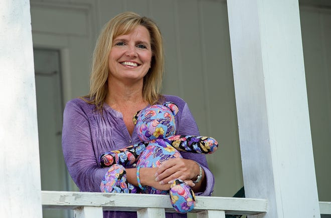 Danette Edwards holds one of the hand-sewn bears made by local volunteer Ann Harvey for children at Family Services of Davidson County. Edwards is the crisis intervention program manager for Family Services, which is offering a volunteer class on Aug. 19 to get more advocates for domestic violence victims. [Donnie Roberts/The Dispatch]