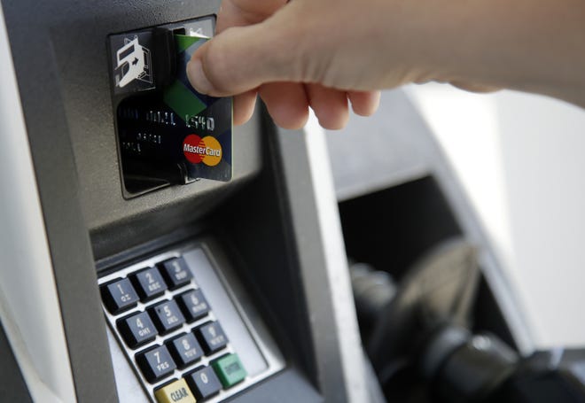 A customer inserts a credit card to buy gas in Haverhill, Mass., on June 15. The more you know about credit cards, how they work and how they fit into your financial life, the more likely you are to use them wisely. [AP Photo/Elise Amendola]