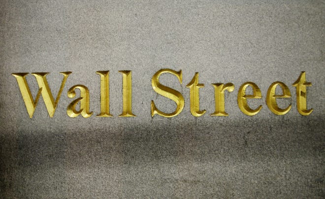 In this Oct. 8, 2014, file photo, a Wall Street address is carved in the side of a building in New York. Gains among technology companies helped snap a three-day losing streak for U.S. stocks Friday, though the market ended with its worst weekly loss since March.

[AP Photo/Mark Lennihan]