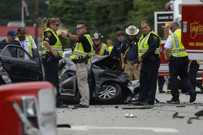 First responders and law enforcement offivers look over a the scene of a multiple vehicle crash on Ramsey Street at the intersection of Summerchase Drive on June 7. [Melissa Sue Gerrits/The Fayetteville Observer]