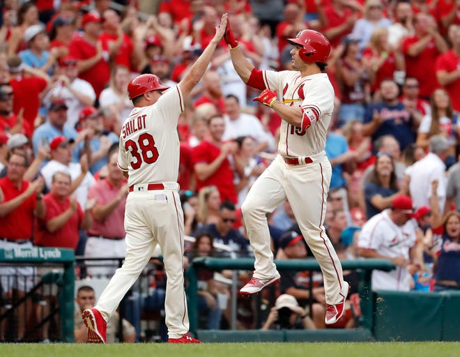St. Louis Cardinals' Randal Grichuk, right, is congratulated by third base coach Mike Shildt after hitting a solo home run during the second inning of the team's baseball game agains the Atlanta Braves on Saturday, Aug. 12, 2017, in St. Louis. (AP Photo/Jeff Roberson)