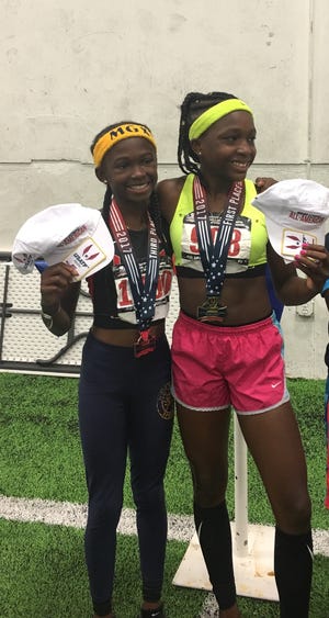 Fayetteville's JaMessia Ford, left. celebrates her victory in the 200-meter dash over rival Cha'iel Johnson, right, at the USATF Hershey National Junior Olympics last month in Lawrence, Kansas. [Walter Ford]
