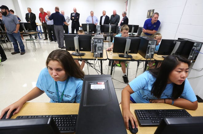 TIMES-REPORTER PAT BURK

Lena Strauss (left) 13, and Aleia Alsept, 13, both of New Philadelphia, work on their Auto CAD drawings to build paper cars while members of the Workforce Development Committee watch during a Manufacturing Camp for students at Buckeye Career Center in New Philadelphia.
