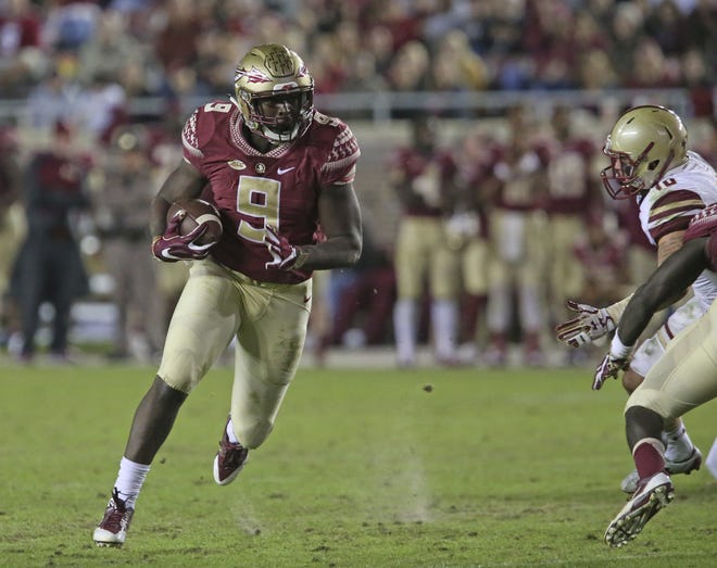This Nov. 11, 2016 photo shows Florida State's Jacques Patrick looking for running room against Boston College's defense in an NCAA college football game in Tallahassee. After two years of being behind Dalvin Cook on the depth chart, Jacques Patrick is ready to take the lessons he learned from watching Cook and become Florida State's lead running back this season. [STEVE CANNON / ASSOCIATED PRESS]
