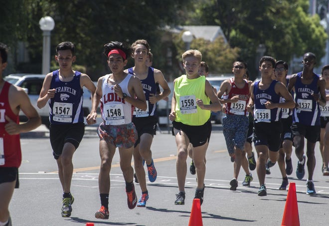 Runners compete in the high school boys race at the fifth annual Lodi Mile held on Sunday at Hutchins Street Square in Lodi. [CLIFFORD OTO/THE RECORD]