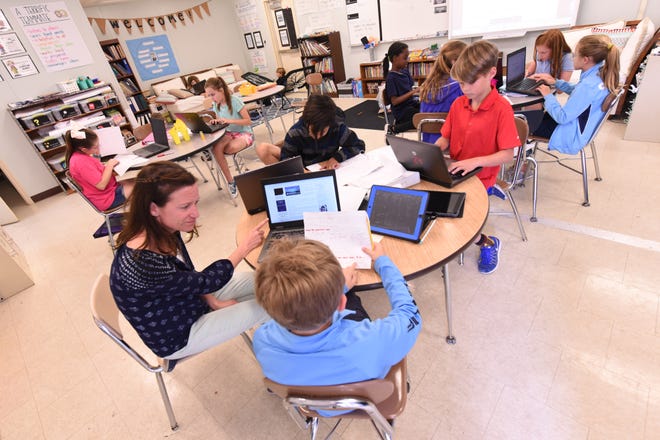 Christy Howe works with students in her AIG class in a mobile classroom at Bradley Creek Elementary May 9 in Wilmington. Teacher pay and elementary class sizes will be hot topics this year. [STARNEWS FILE PHOTO]