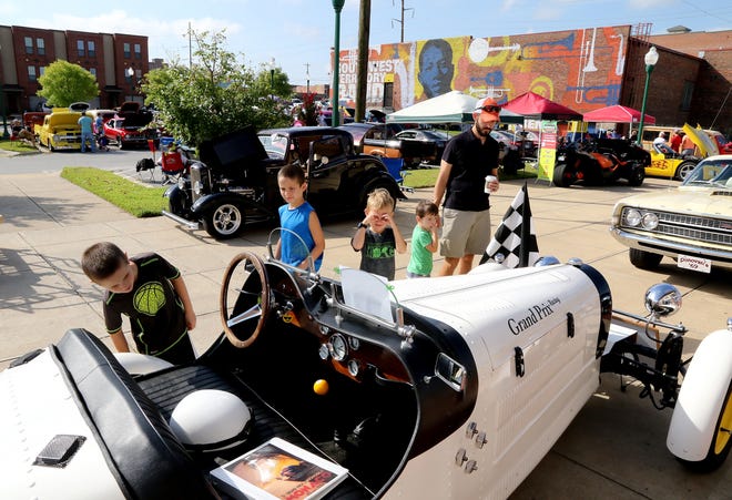 Bryan Johnson, right, and his sons, from left, Bryce, Lucas, Myles and Sylas, look over the replica 1927 Bugatti T35 "Grand Prix," on display Saturday, Aug. 12, 2017, during Fort Smith Boys Shelter's Car Show & Silent Auction at the Glass Pavilion. More than 70 cars and trucks were displayed ranging from antiques and classic collections to hot rods and muscle cars. The annual car show included raffles, silent auction and vendors selling food and t-shirts. [JAMIE MITCHELL/TIMES RECORD]