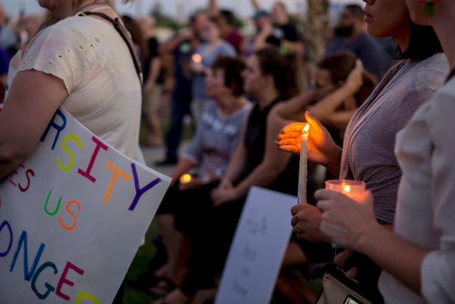 Candles are held during a vigil for victims in Charlottesville, Va., at the Rev. Dr. Martin Luther King Jr., Memorial Statue in North Las Vegas, Nev., Sunday, Aug. 13, 2017. Protesters decrying hatred and racism converged around the country on Sunday, saying they felt compelled to counteract the white supremacist rally that spiraled into deadly violence in Virginia. (Elizabeth Brumley/Las Vegas Review-Journal via AP)