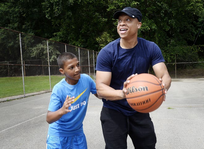 Ascheley Brown of Rochester plays a game of one-on-one basketball with Dayvon Cox, 13, of Beaver Falls, recently. Brown mentors Cox through My Brother's Keeper, a mentorship program based in Beaver Falls.