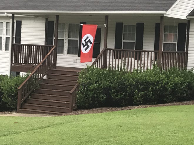 This Nazi flag still flew in front of Joe Love's Gaston County residence on Monday morning. 

[Adam Lawson/The Gaston Gazette]