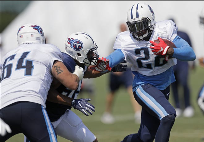 Tennessee Titans running back Derrick Henry (22) runs the ball during NFL football training camp in Nashville, Tenn., on Aug. 9, 2017. Henry says it was "different" coming off winning a Heisman Trophy and finding himself the backup as an NFL rookie. Now in his second season with the Titans behind Pro Bowl running back DeMarco Murray, Henry calls that a growth year for him as he works every day as if he is the starter. [AP Photo/Mark Humphrey, File]