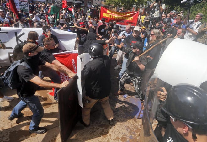 White nationalist demonstrators clash with counter demonstrators at the entrance to Lee Park in Charlottesville, Virginia on Saturday.