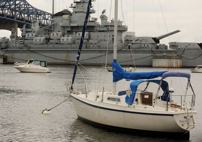 The sloop "Snow Goose" sits at a mooring in Battleship Cove.