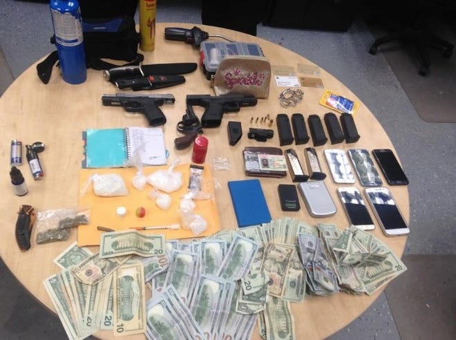 Officers with the Panama City Police Department reported finding several types of drugs, weapons and $6,000 in cash inside a vehicle parked outside a 23rd Street bank Saturday. [COURTESY OF PCPD]