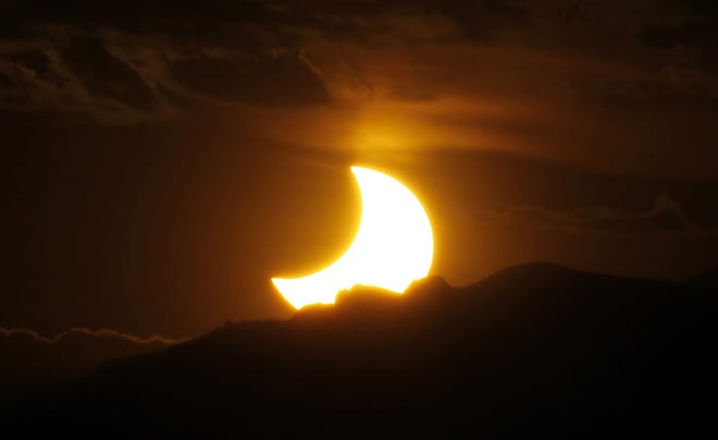 A solar eclipse over Denver. [AP archive / 2012 / David Zalubowski]