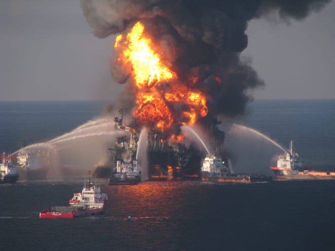 Fire boats spray water on the burning BP Deepwater Horizon offshore oil rig in April 2010. Besides proposing to expand drilling off both Florida coasts, President Donald Trump's executive order calls for revising well-control regulations established in response to the Deepwater Horizon disaster. [The Associated Press]
