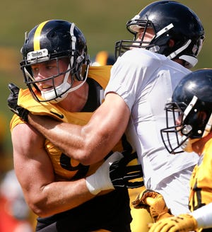 Pittsburgh Steelers linebacker T.J. Watt, left, tries to get through a block by tight end Jesse James (81) in drills during NFL football training camp in Latrobe, Pa., Wednesday, Aug. 16, 2017. The rookie linebacker had two sacks in his preseason debut last week, leaving both the Steelers coaching staff and older brother J.J. impressed.(AP Photo/Keith Srakocic)