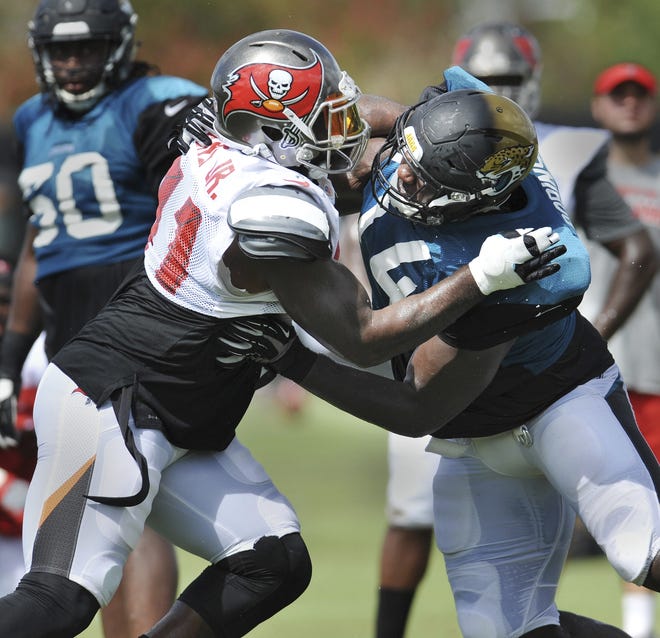 Tampa Bay Buccaneers defensive end Robert Ayers Jr., left, goes against Jacksonville Jaguars offensive lineman Cam Robinson during a joint NFL football practice earlier this week in preparation for tonight's preseason game. [WILL DICKEY/GATEHOUSE MEDIA SERVICES]