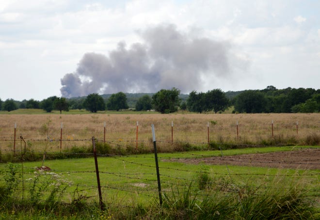 Smoke from the daily detonation of demilitarized ammunition at the McAlester Army Ammunition Plant can be seen from a field in Savanna. [Photo by Tricia Pemberton, for The Oklahoman]